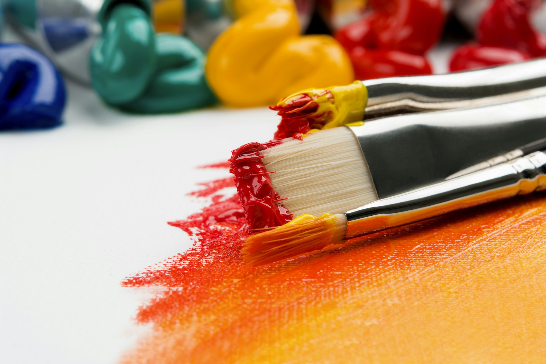 Paint and brushes in a working art studio